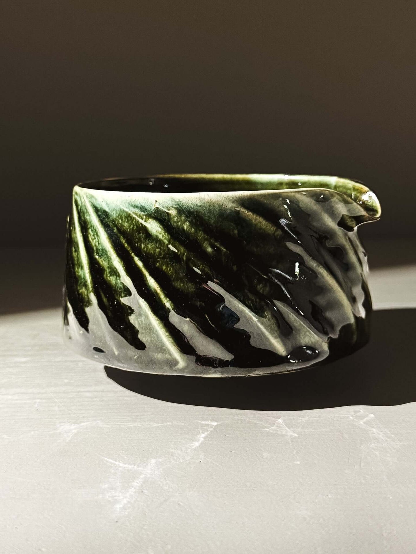 Textured Matcha Bowl Spout - Hinoki #01 with glossy green glaze and hand-applied slip decoration, displaying intricate carved details.