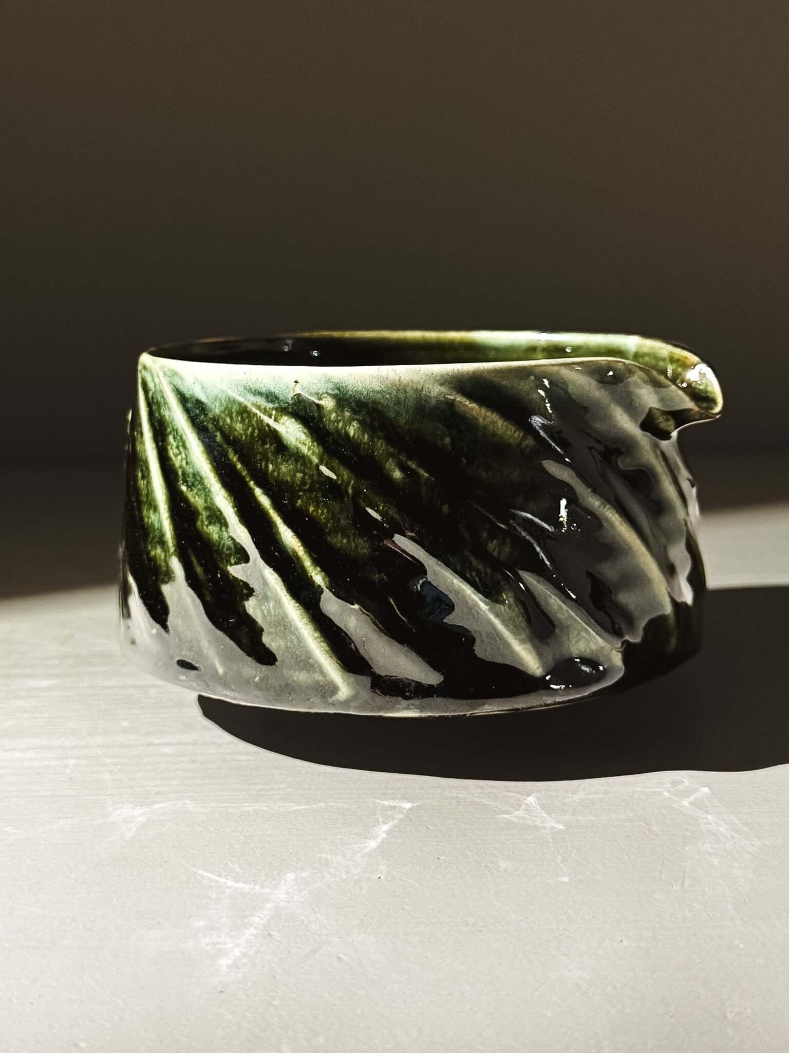 Textured Matcha Bowl Spout - Hinoki #01 with glossy green glaze and hand-applied slip decoration, displaying intricate carved details.