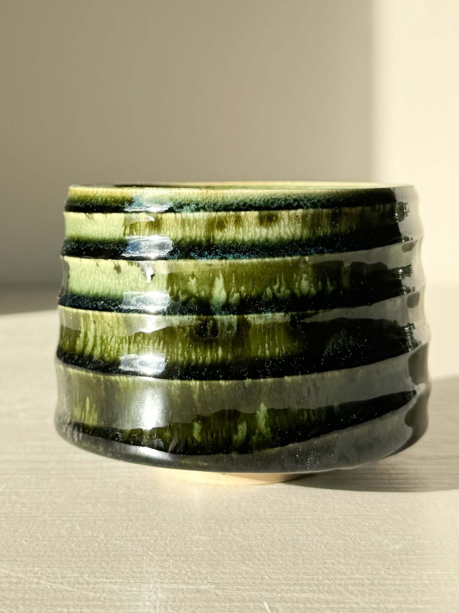 Textured Matcha Bowl - Hinoki #19 with green glaze, inspired by Hinoki tree, showcasing unique textured finish in natural light.