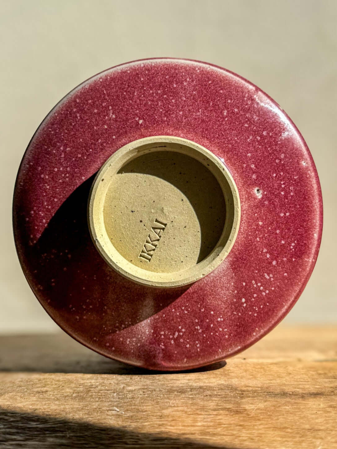 Base view of Matcha Bowl - Ume Series #05 displaying the unique red glaze and the IKKAI inscription.