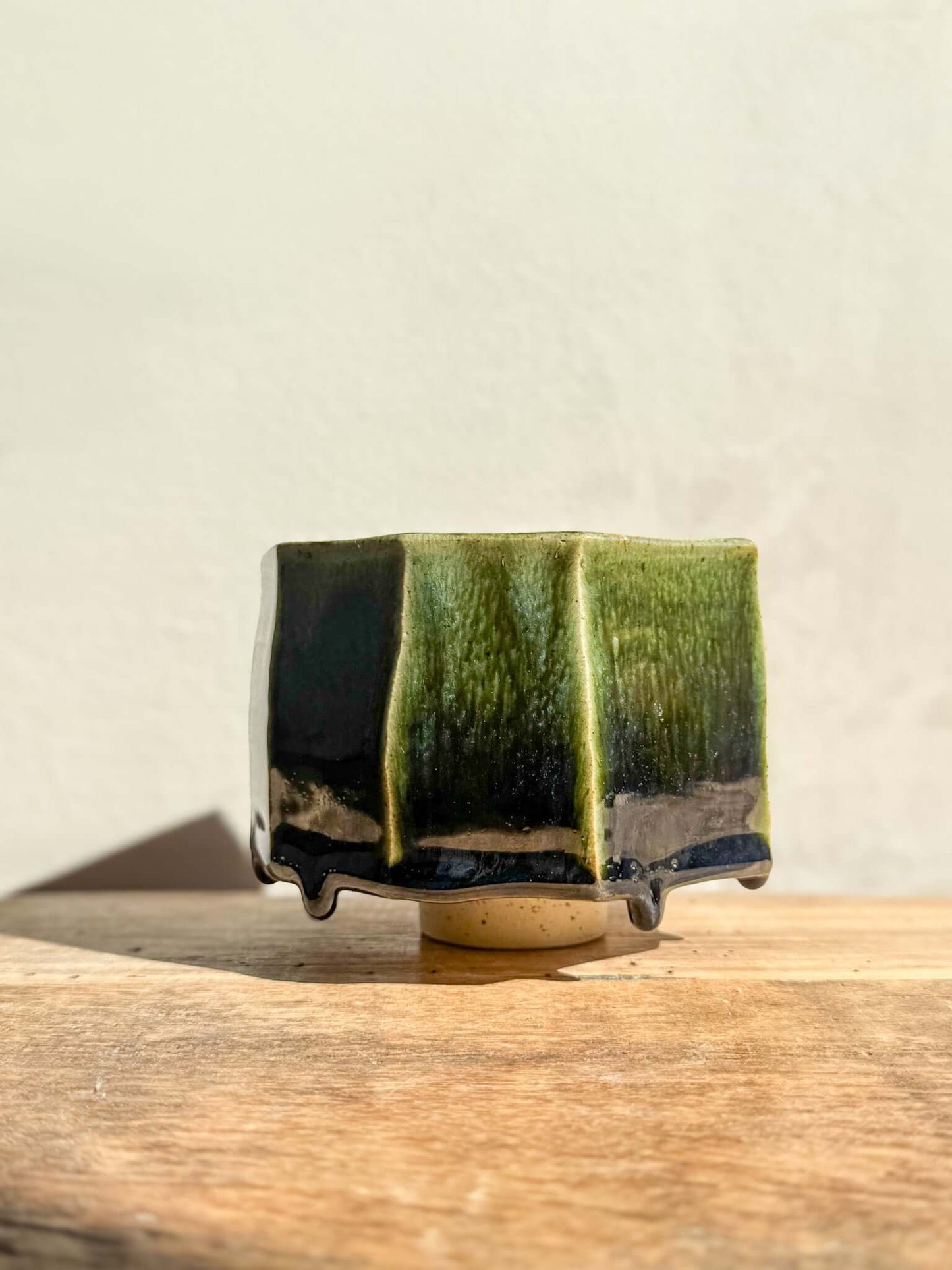 Faceted Matcha Bowl with deep green glaze, part of Hinoki Series #03. Unique handcrafted design with intricate glaze patterns.