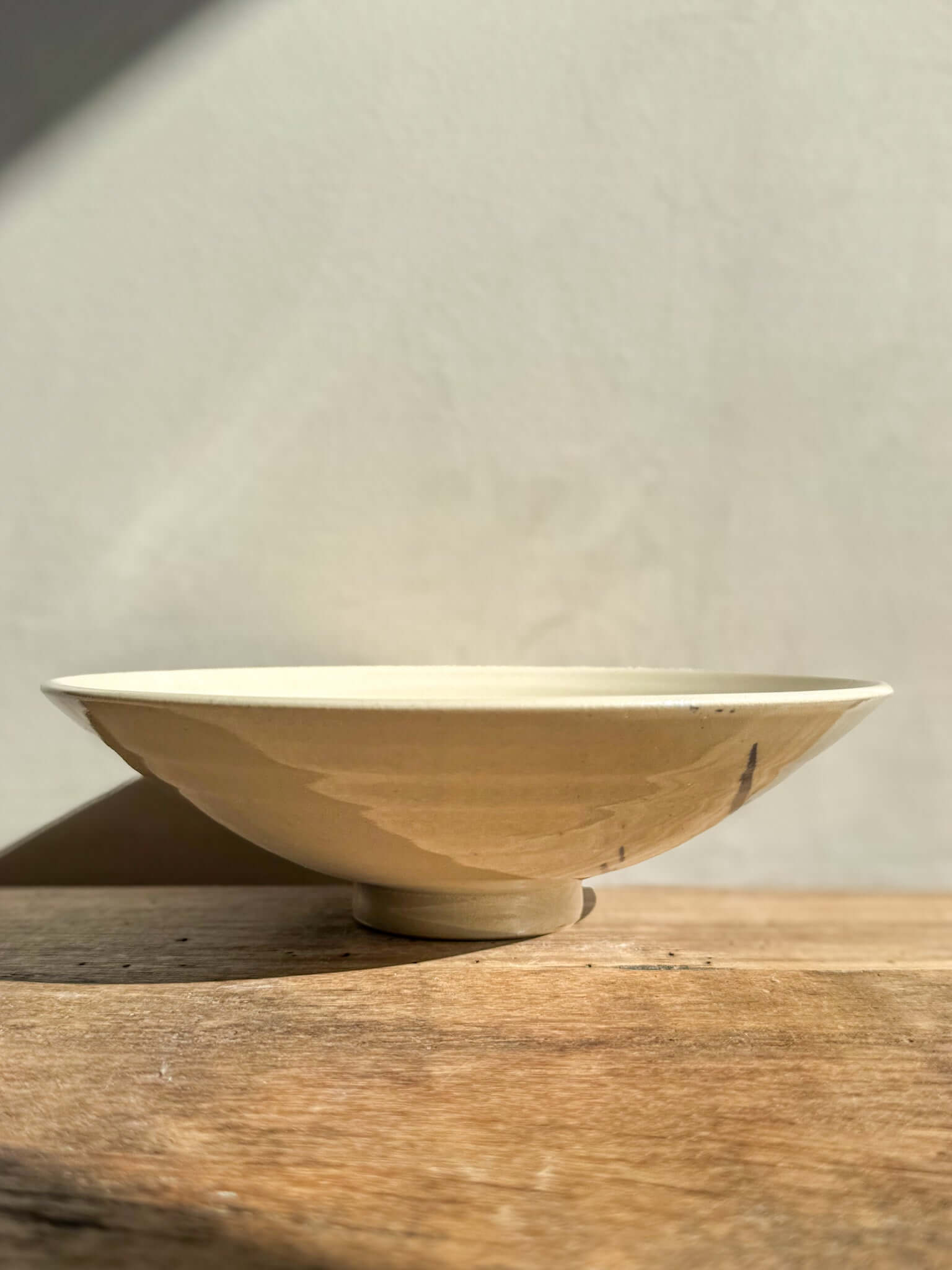"Lidded Serving Bowl from Gosu Series in soft light, showcasing elegant design and natural textures on a wooden surface"