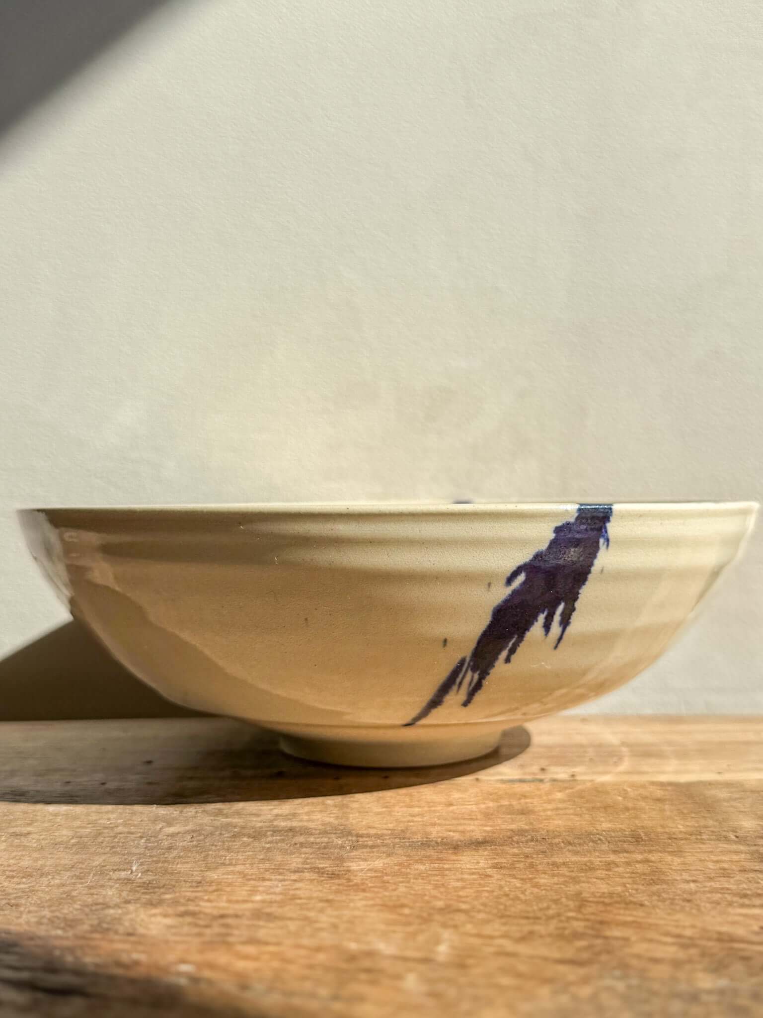 Side view of a Lidded Serving Bowl from the Gosu Series with cobalt splashes, showing the elegant design and handcrafted texture.