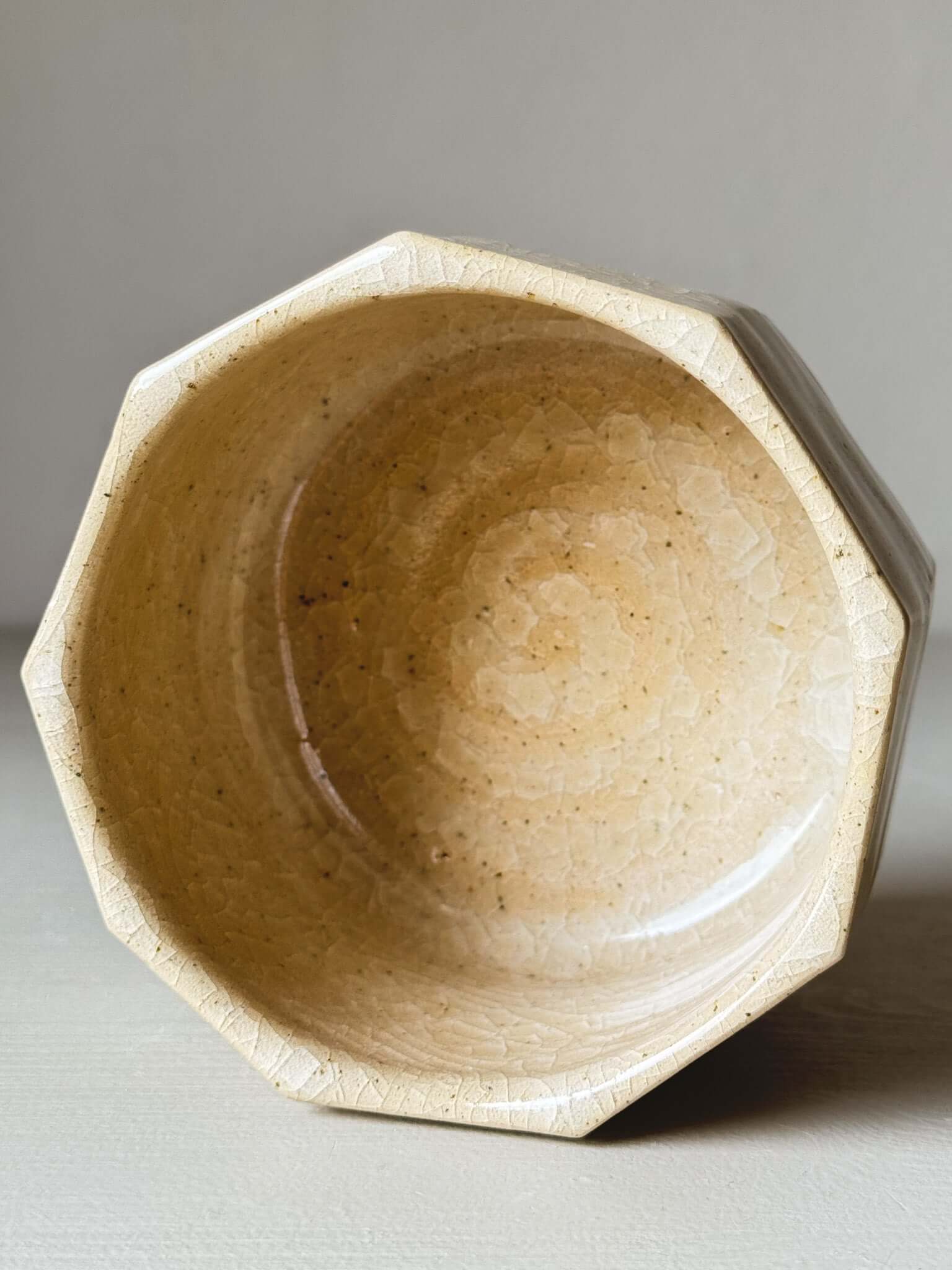 Faceted matcha bowl with honey-toned crackle glaze, featuring geometric design and wabi-sabi aesthetics for slow mornings.
