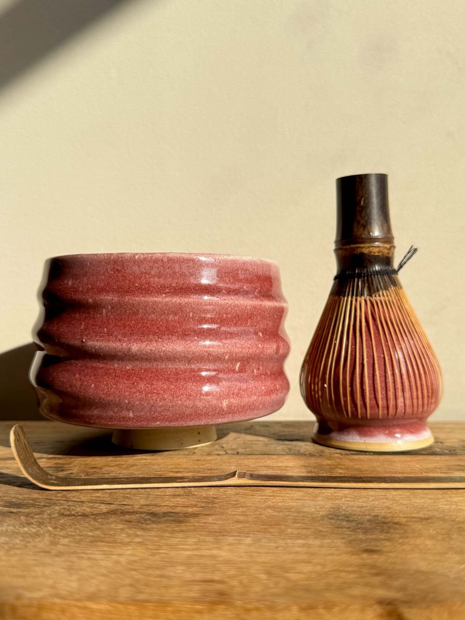 Ceramic Matcha Whisk Holder from Ume Series with bamboo Chasen whisk, inspired by Japanese plum blossom, enhancing tea preparation.