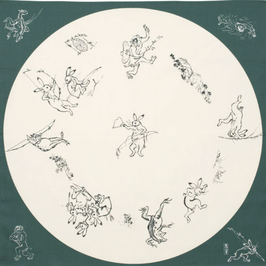 Medium furoshiki with rabbits, frogs, and monkeys in a round window design on green organic cotton cloth.