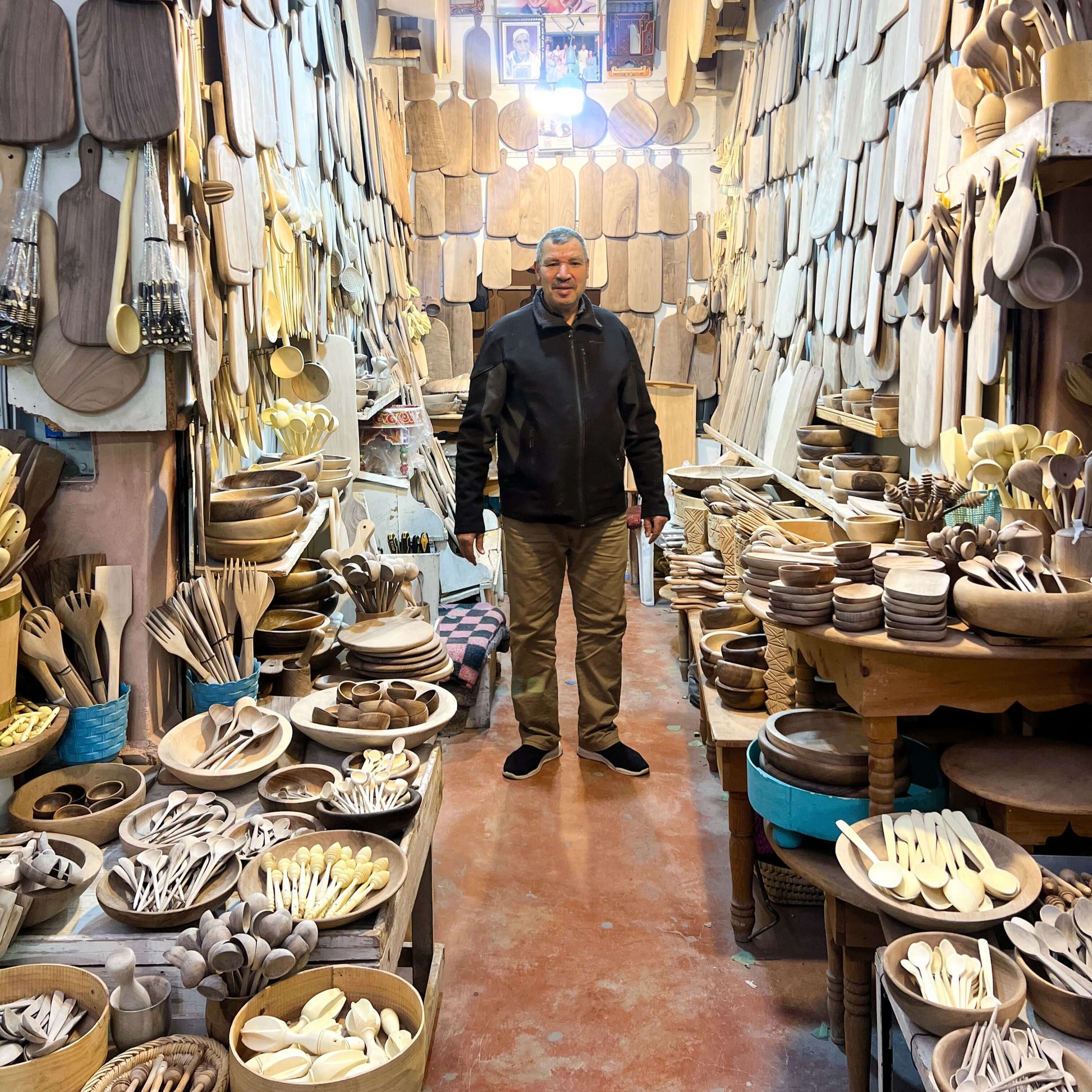 Artisan shop in Marrakech displaying hand-carved wooden utensils and boards, showcasing diverse craftsmanship and design.