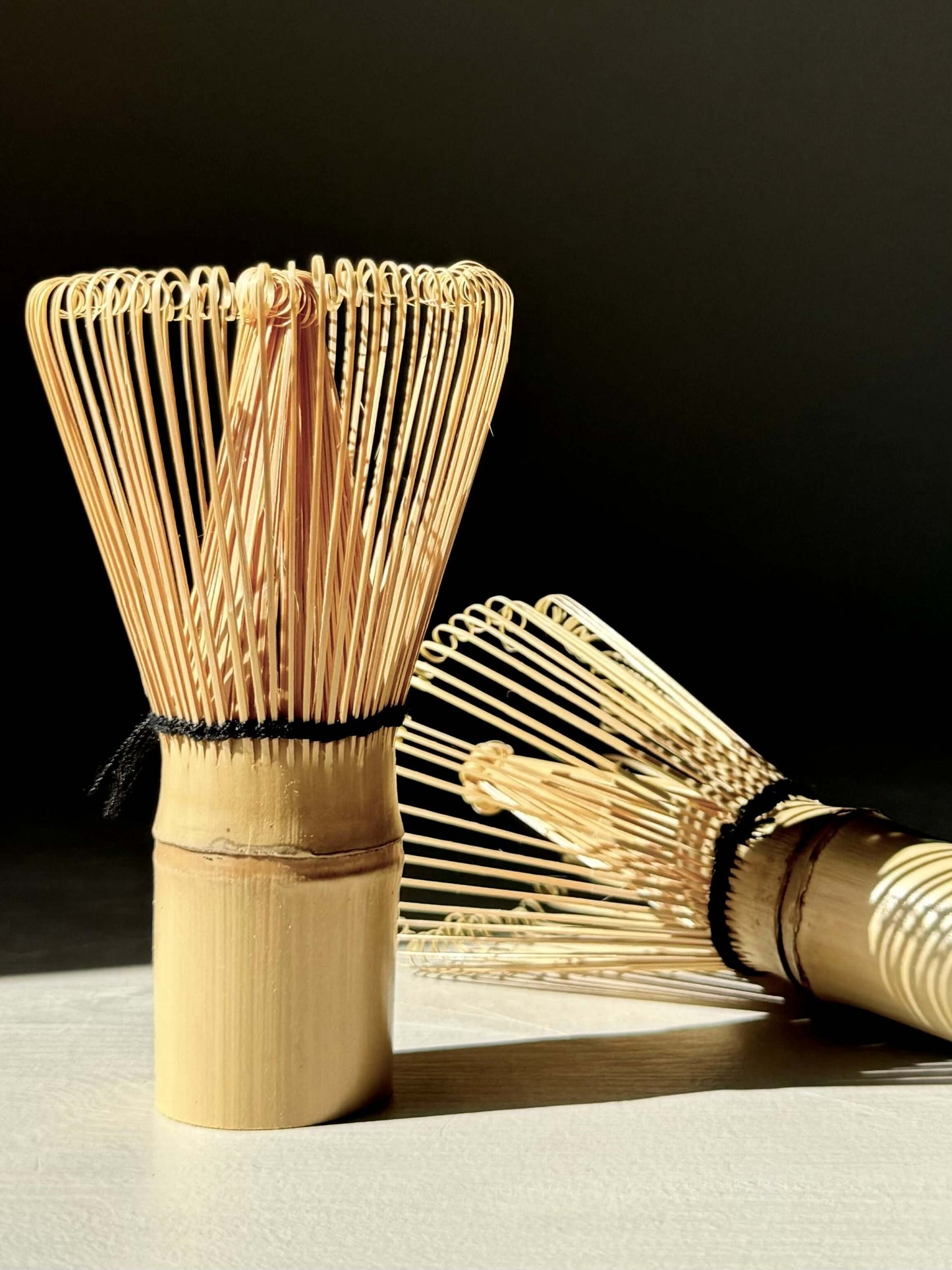 Bamboo matcha whisk (Chasen) with delicate tines for blending matcha tea, creating a smooth and frothy cup. Essential tea tool.