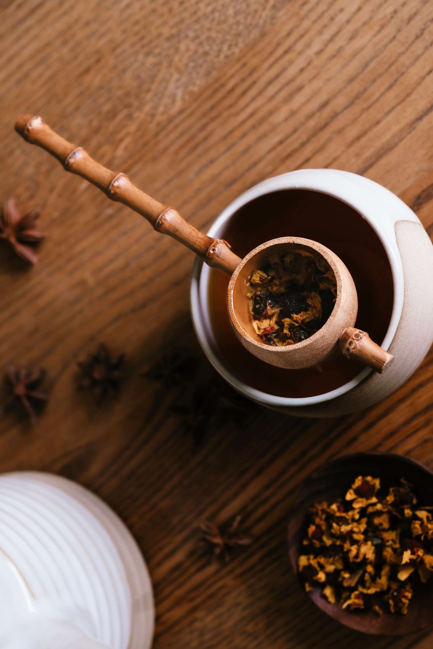 Bamboo Tea Strainer over a handmade ceramic pot, showcasing rustic charm and functionality during tea time.