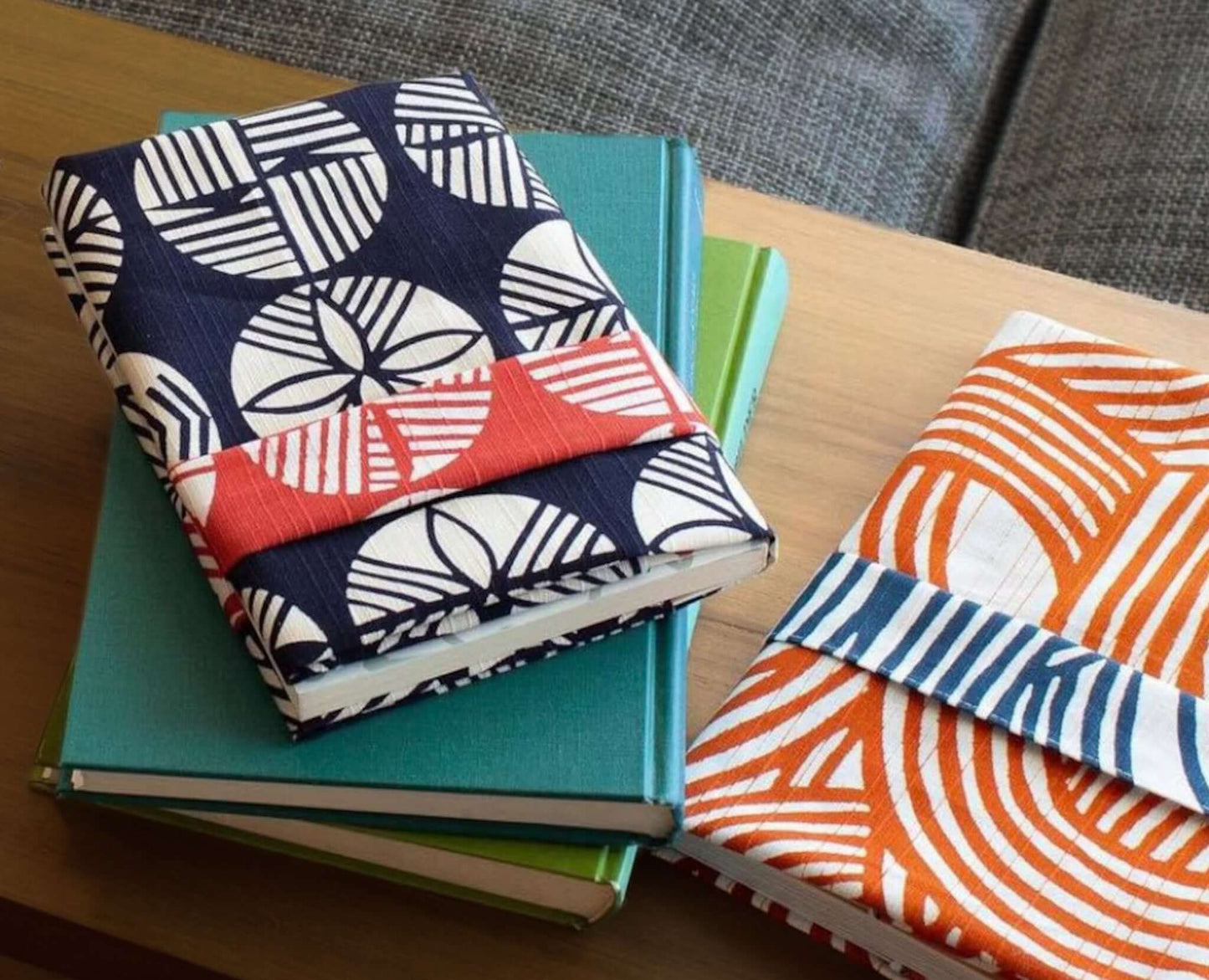 Small Furoshiki isa monyo Pine Navy Blue Red decorative book covers on stacked notebooks.