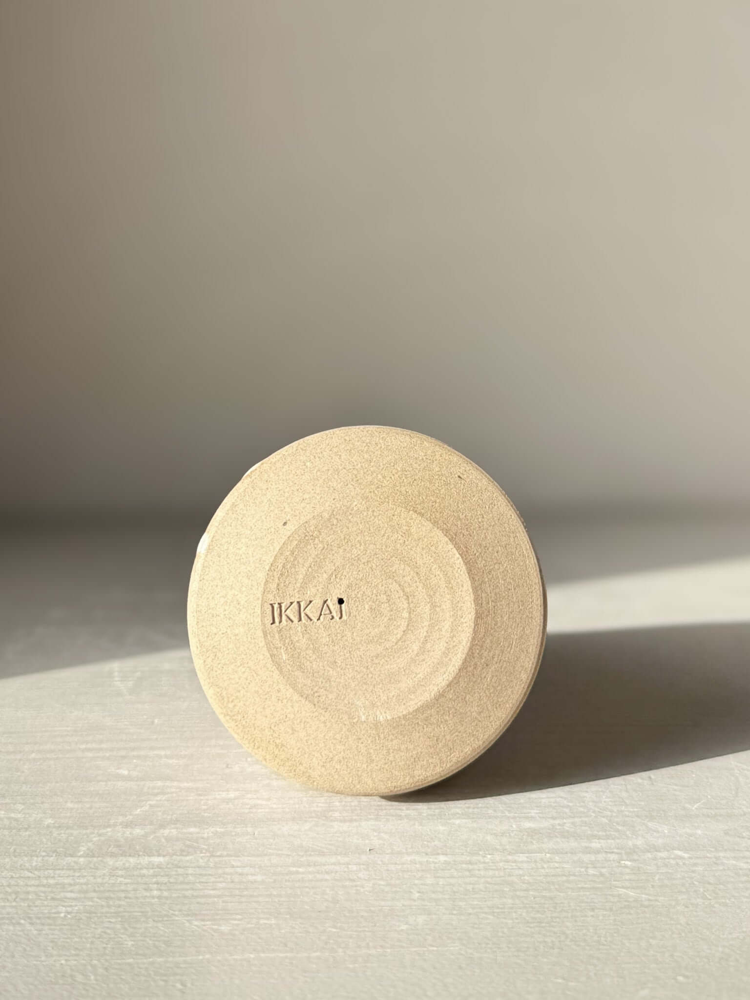 Bottom view of a handmade ceramic item from the Yuki Series, showcasing the textured base and craftsmanship detail.