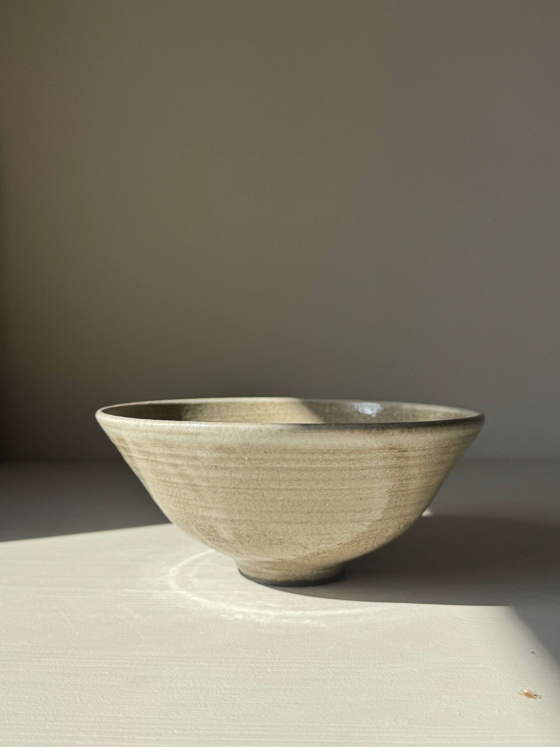 Bowl – Yuki Series Dark Clay, handmade ceramic bowl, elegant wide open shape, trimmed foot, soft white glaze finish.