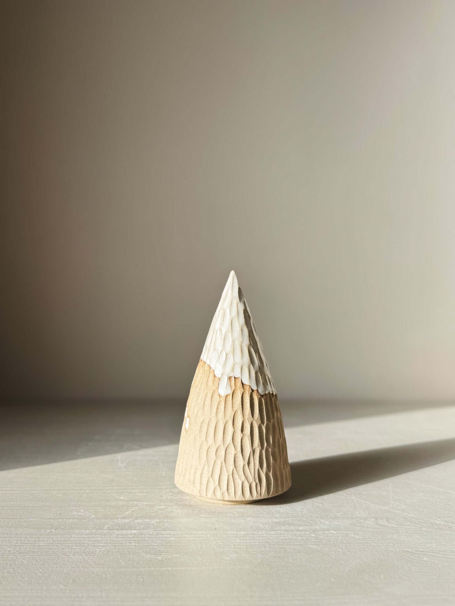 Carved Ceramic Tree – Yuki #02 with glossy white glaze on a textured surface, showcasing the craftsmanship and minimal design.