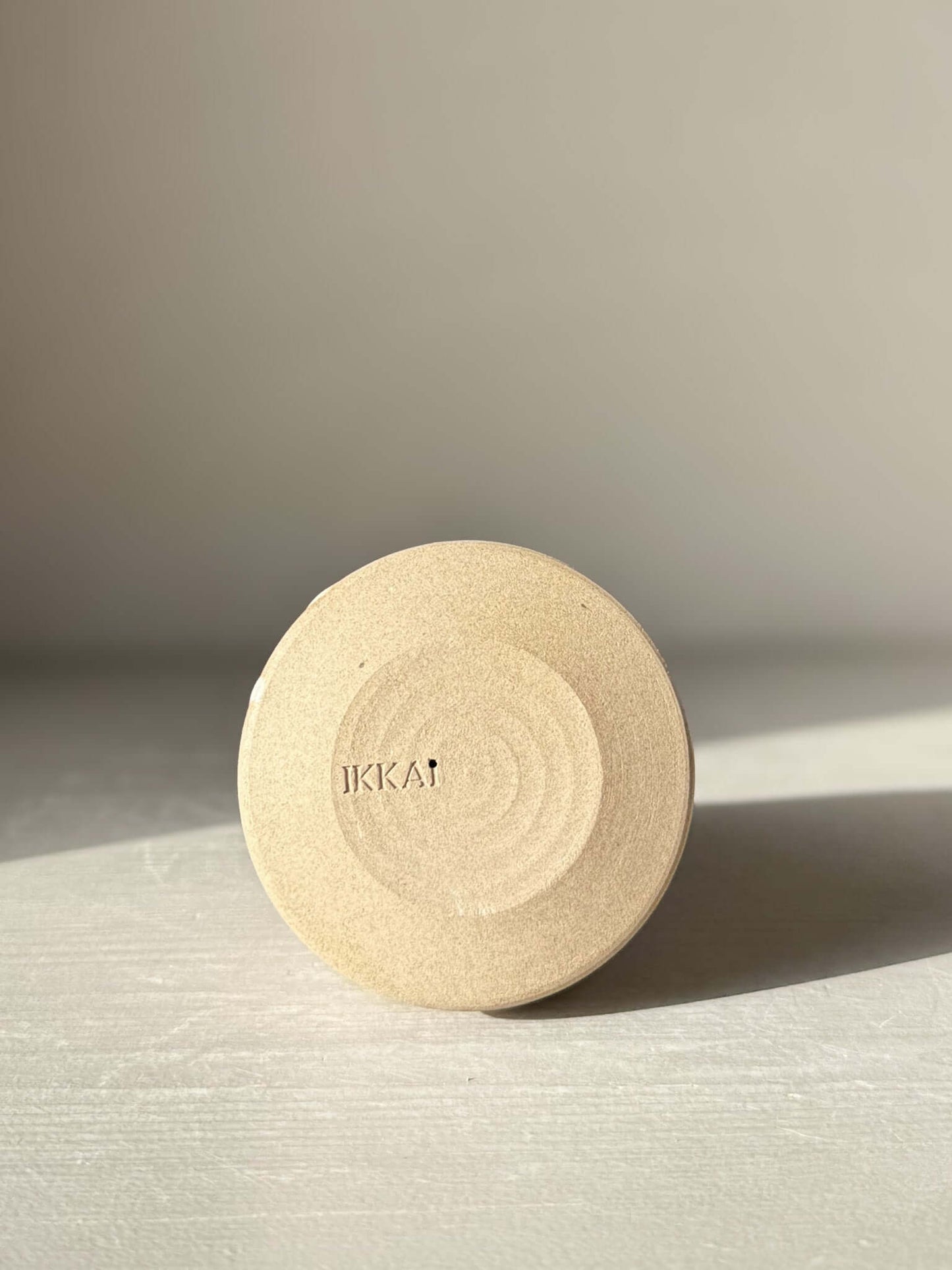 Bottom view of a handmade ceramic item from the Yuki Series, showcasing the textured base and craftsmanship detail.