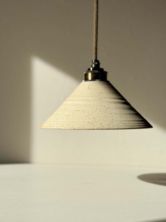 Ceramic Lamp Shade with half clear glaze, showcasing a textured unglazed exterior and smooth interior for cozy lighting.