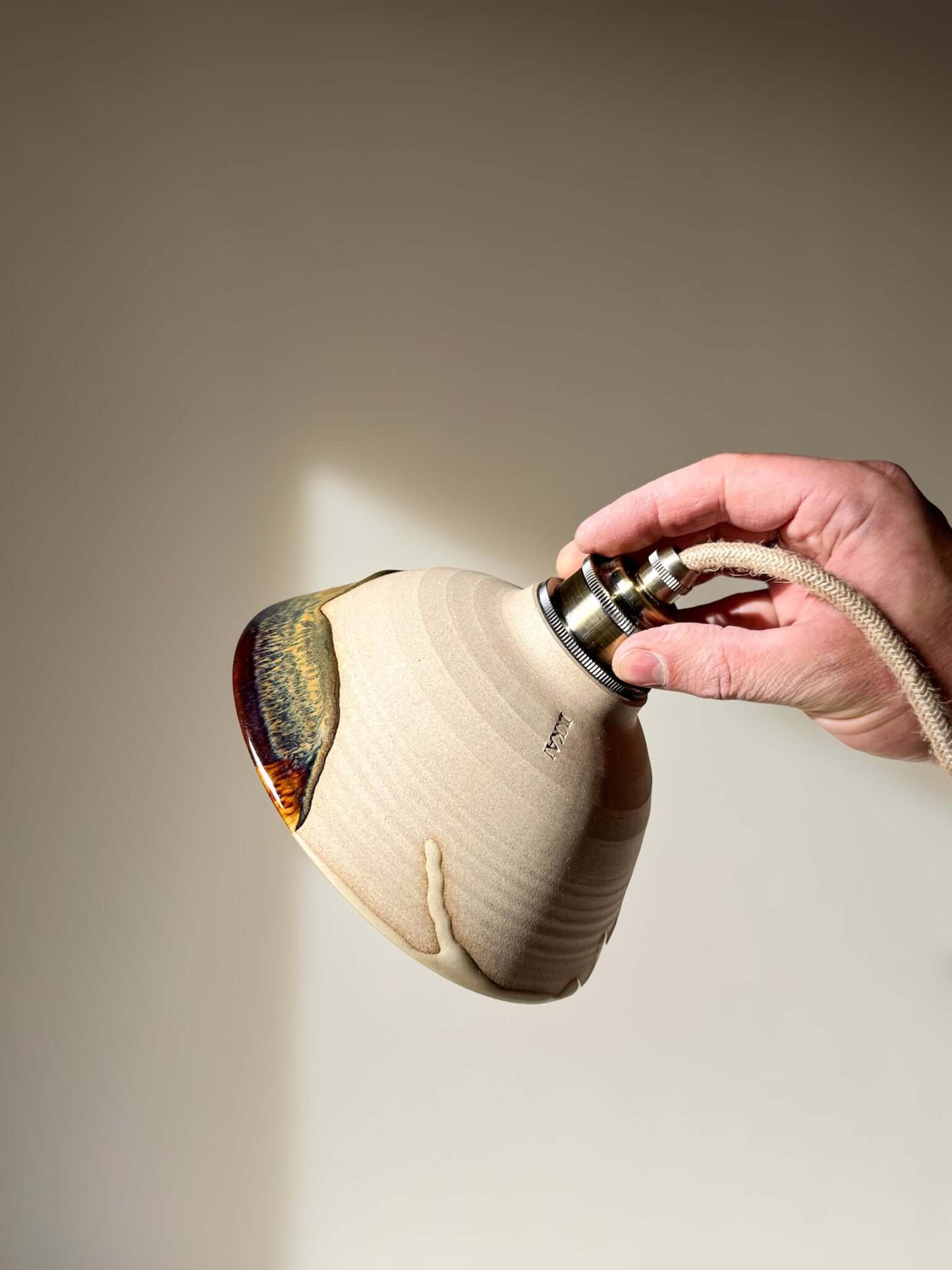 Hand holding Ceramic Lamp Shade – Inyo #01 with glaze drips and handmade ceramic finish.