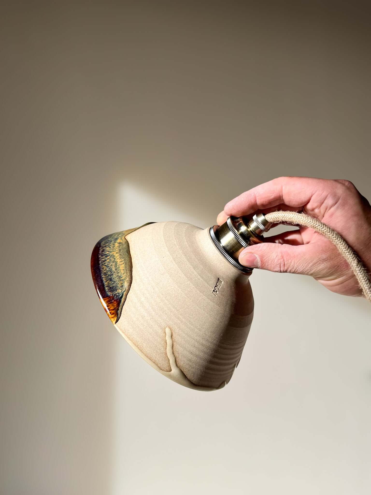 Hand holding Ceramic Lamp Shade – Inyo #01 with glaze drips and handmade ceramic finish.
