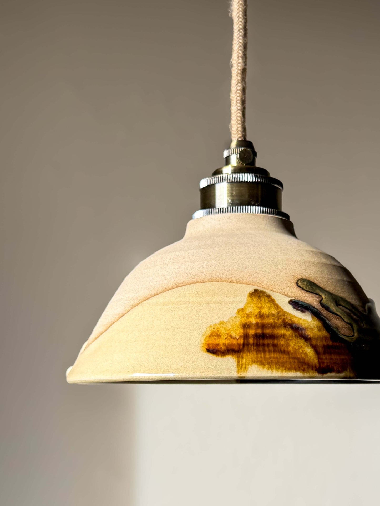 Handmade Ceramic Lamp Shade – Inyo #01 with bronze, amber, and blue glaze drips creating a soft, natural finish.