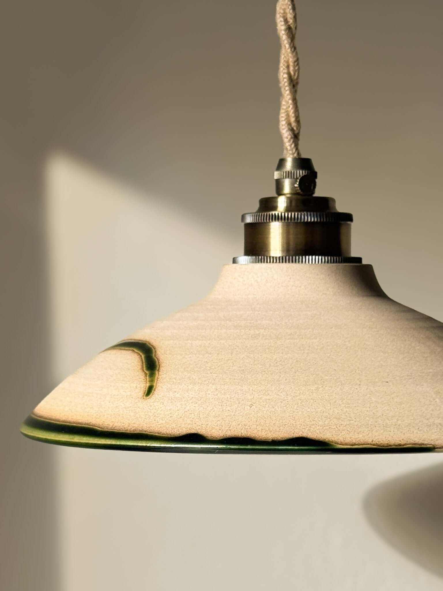 Ceramic Lamp Shade – Mori #02 in soft natural tones with forest green, showcasing raw clay beauty and handmade ceramic design.