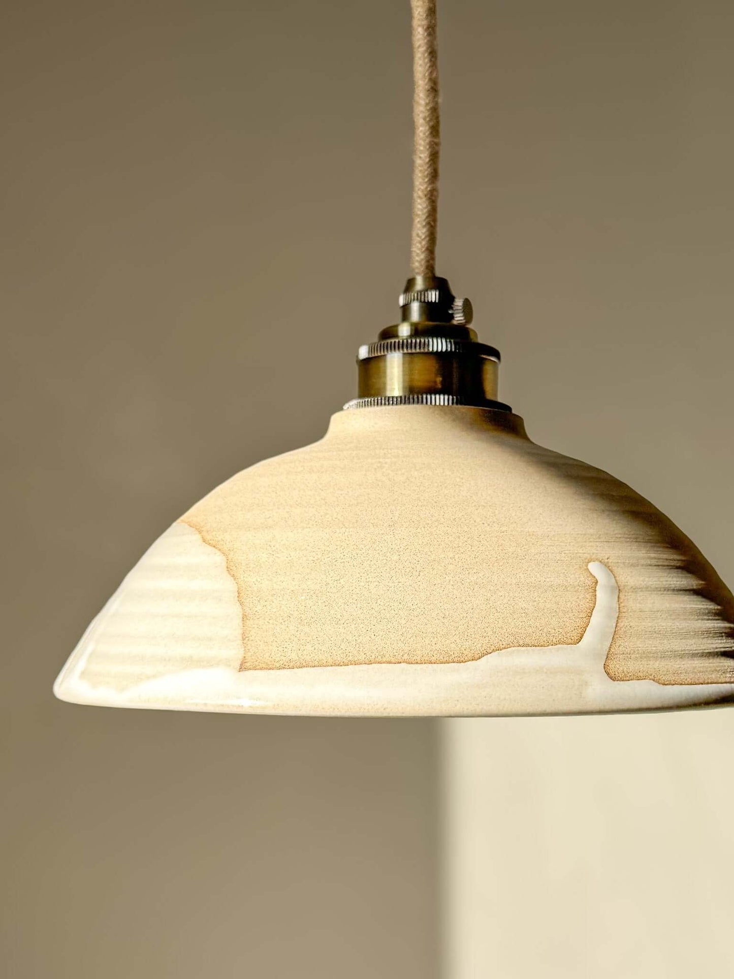 Ceramic Lamp Shade – Yuki #01 - Custom Order hanging above a neutral background, showcasing its creamy glaze and design.