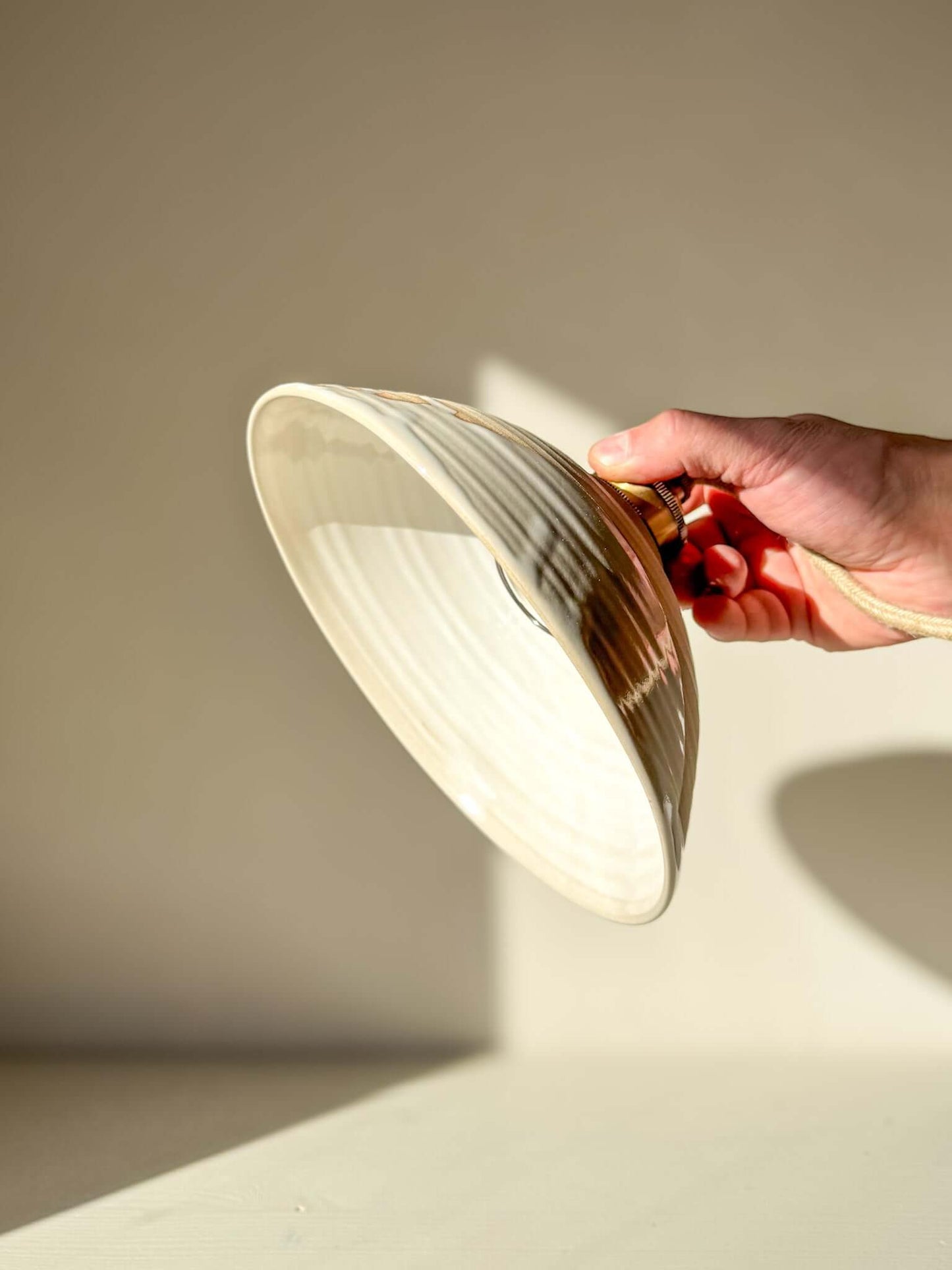 Ceramic Lamp Shade – Yuki #01 - Custom Order being held, showing glossy white glaze and creamy rim design.