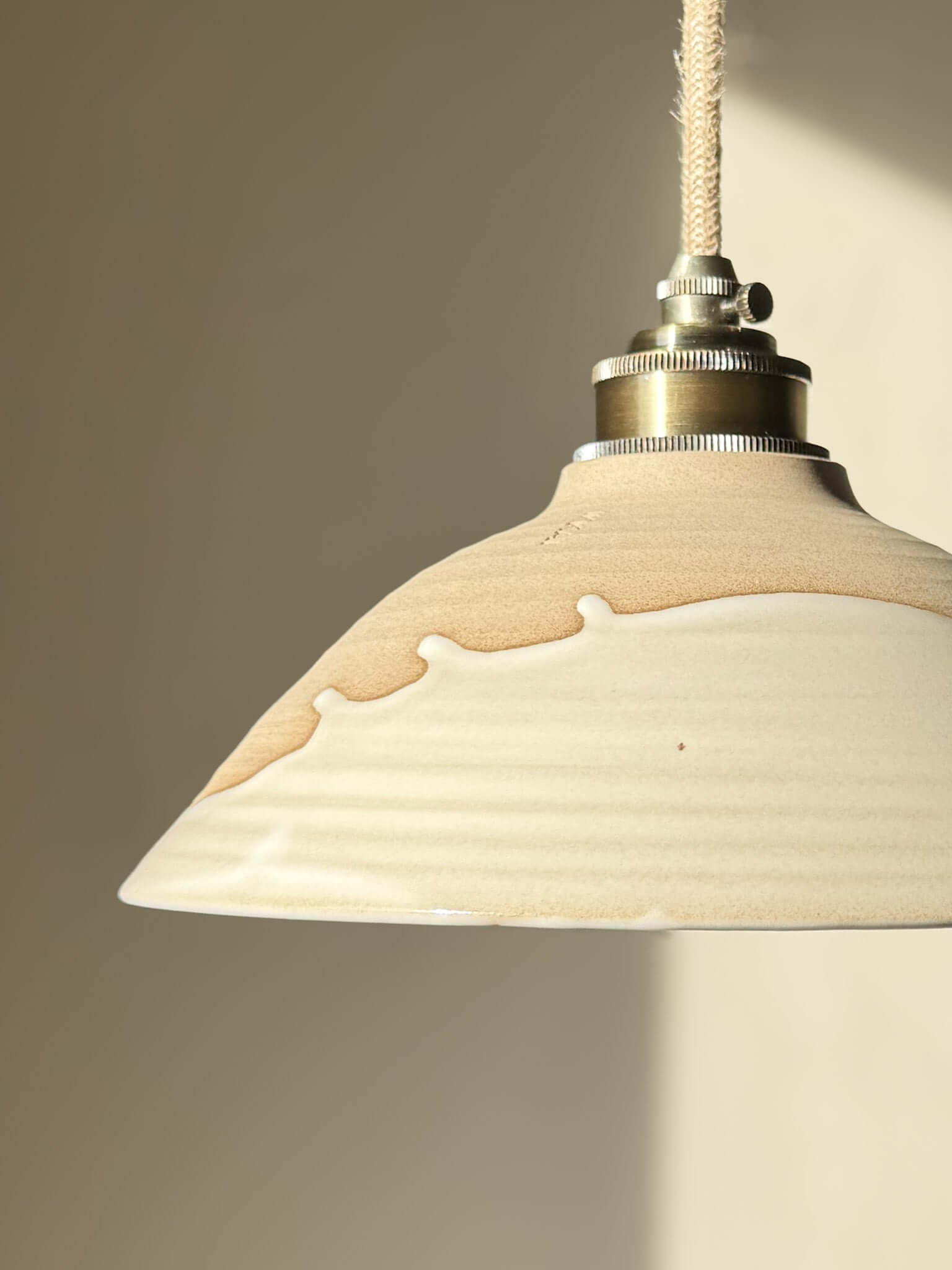 Ceramic Lamp Shade – Yuki #02 with glossy white glaze and raw clay finish, showcasing a calm, snowy softness and elegant slanted profile.