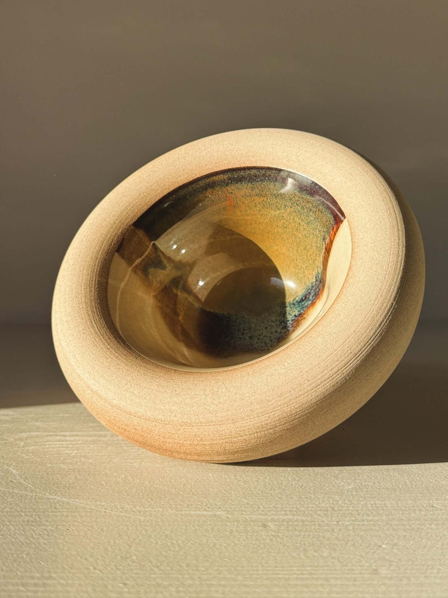 Double-Walled Bowl - Inyo #01 with raw toffee-toned clay exterior and glazy interior showcasing browns, golds, and blues.