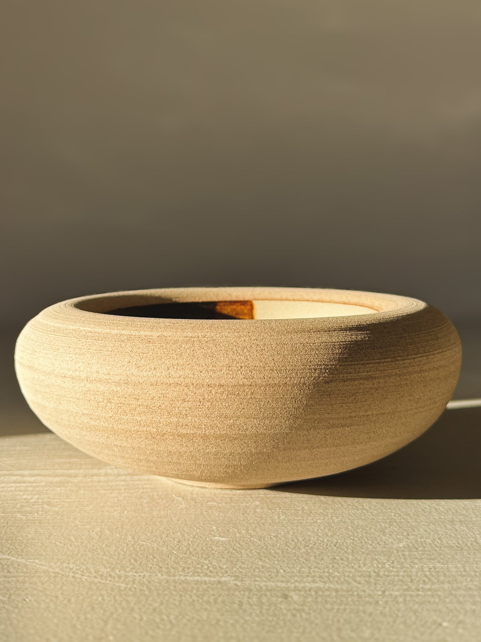 Double-Walled Bowl - Inyo #03 with warm toffee-toned clay and rounded design, showcasing clear and tenmoku glazes inside.