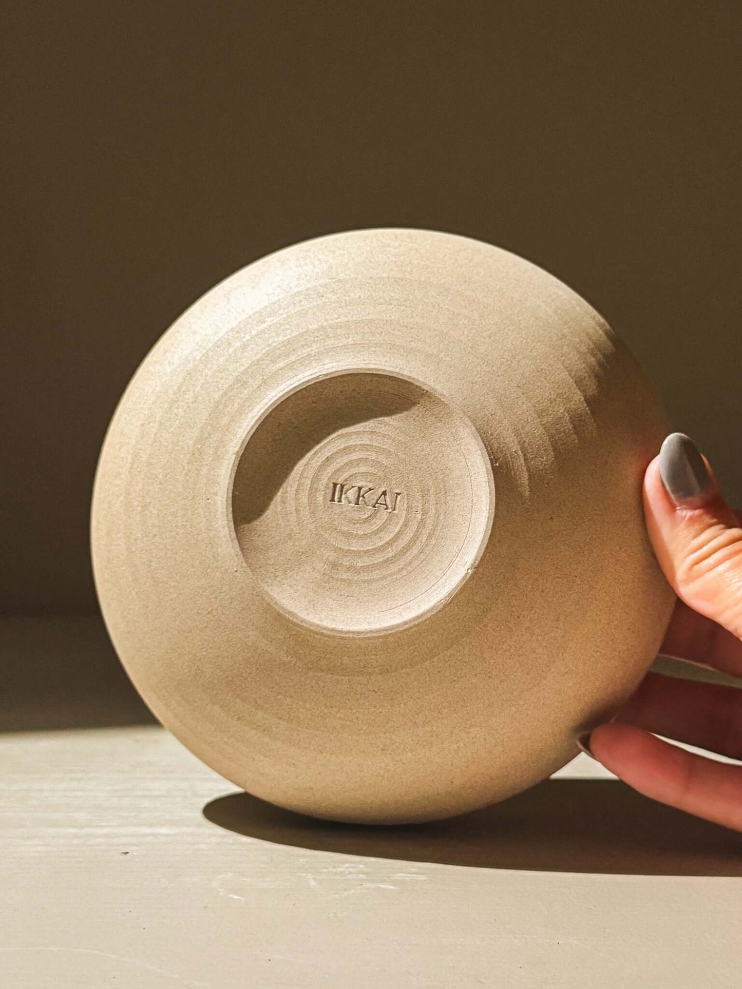 Handmade stoneware bowl with raw toffee-toned clay, showcasing intricate throwing lines, part of the Inyo Series, double-walled design.