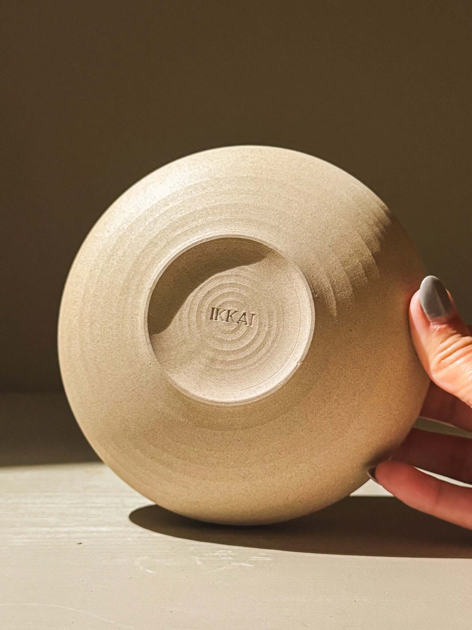 Handmade stoneware bowl with raw toffee-toned clay, showcasing intricate throwing lines, part of the Inyo Series, double-walled design.