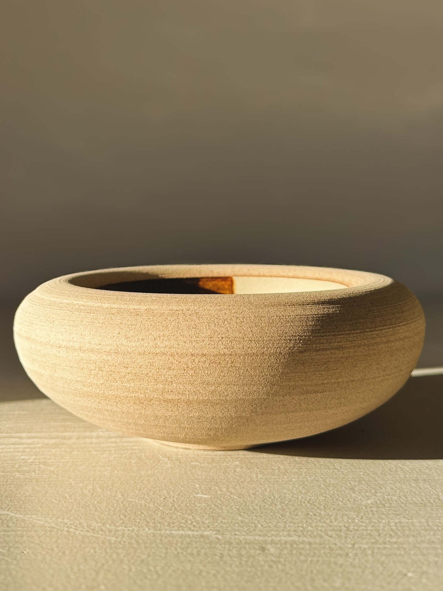 Double-Walled Bowl - Inyo #03 with warm toffee-toned clay and rounded design, showcasing clear and tenmoku glazes inside.