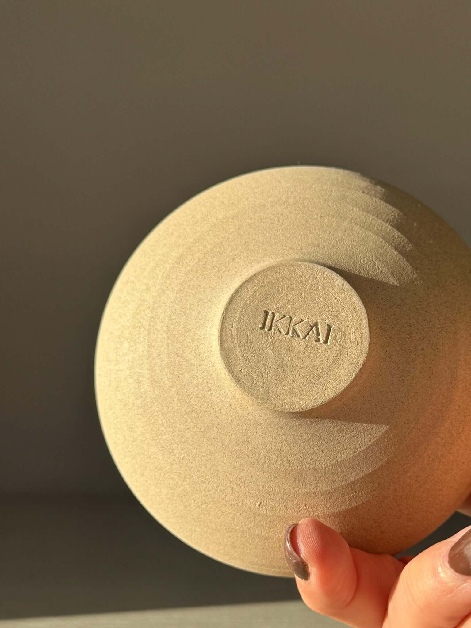 Underside of Double-Walled Bowl - Inyo #04 showing dusty toffee-toned clay with handcrafted details and a subtle IKKAI imprint.