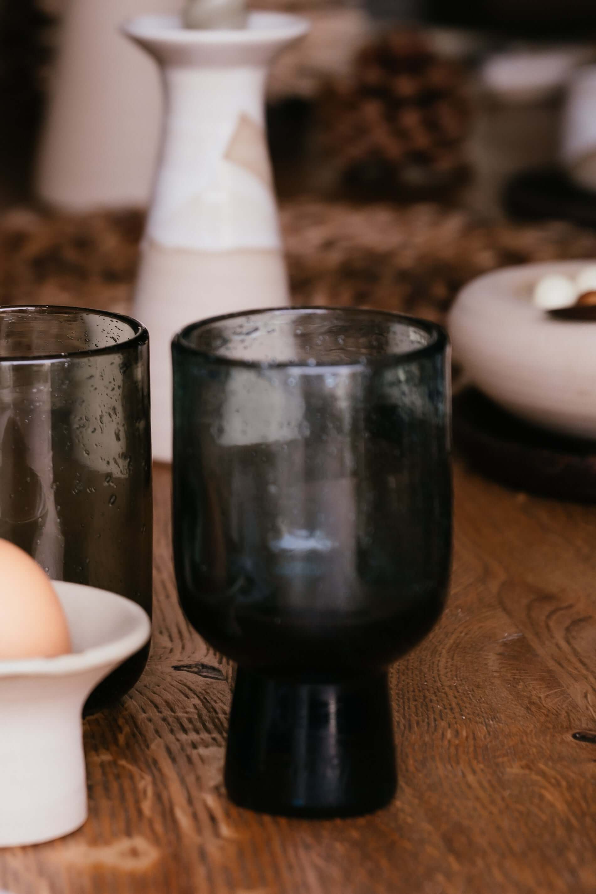 Grey Pedestal Glass – Natural Bubbled Glass with handmade ceramic elements on a wooden table