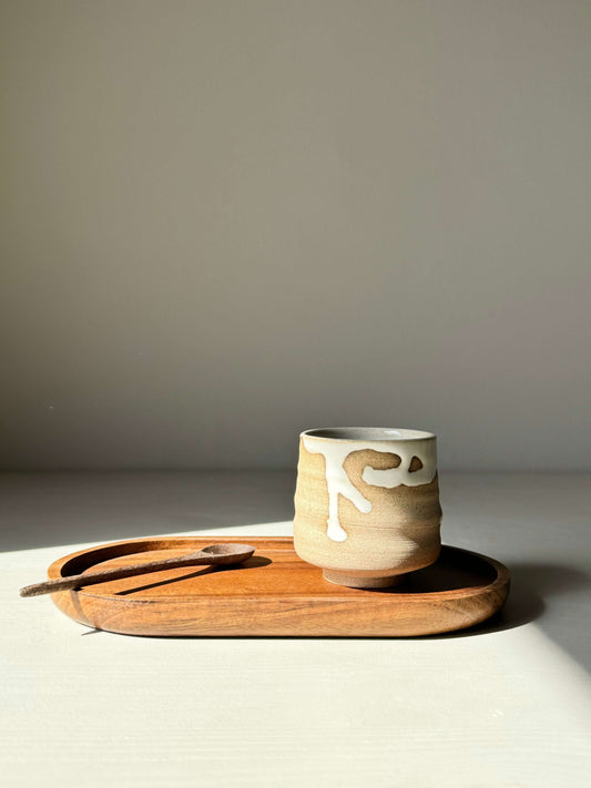 Yuki Series espresso cup with white glaze on wooden tray, inspired by snow stillness, showcasing natural clay tones and elegant design.