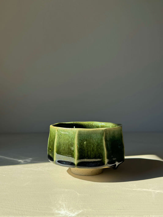 Faceted Matcha Bowl from Hinoki Series in green and black glaze, low wide form with carved ridges and lifted foot, 02 edition.
