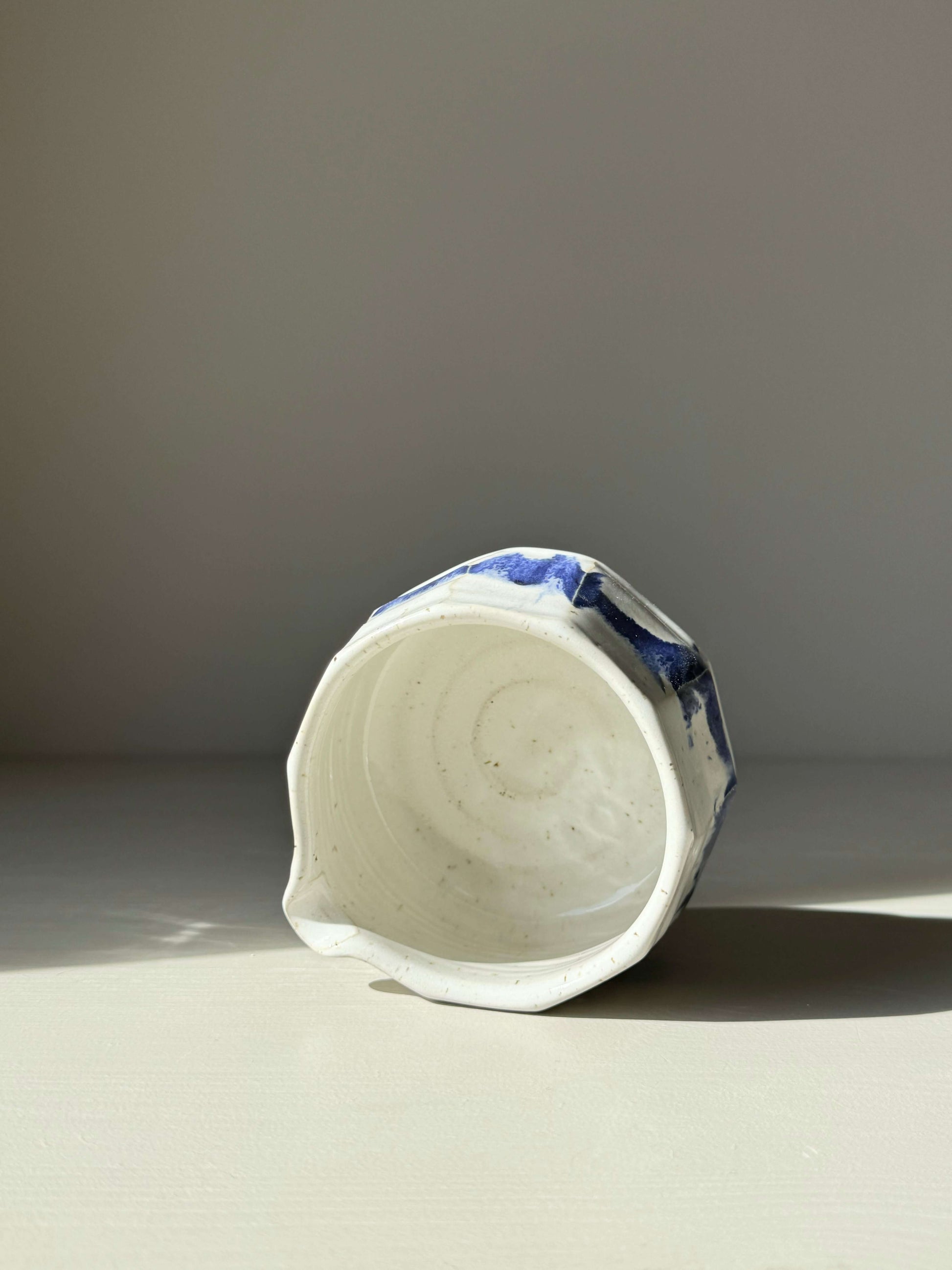 Faceted Matcha Bowl with Spout in Cobalt Blue and Glossy White Glaze, showcasing its unique hand-splashed design and modern aesthetic.