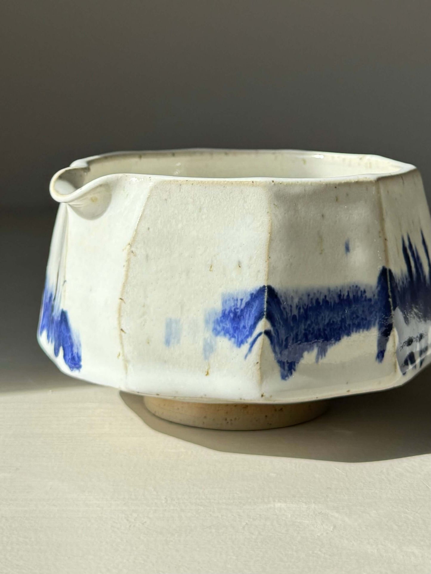 Faceted Matcha Bowl with spout in cobalt blue and glossy white glaze, featuring a modern design with hand-splashed accents.