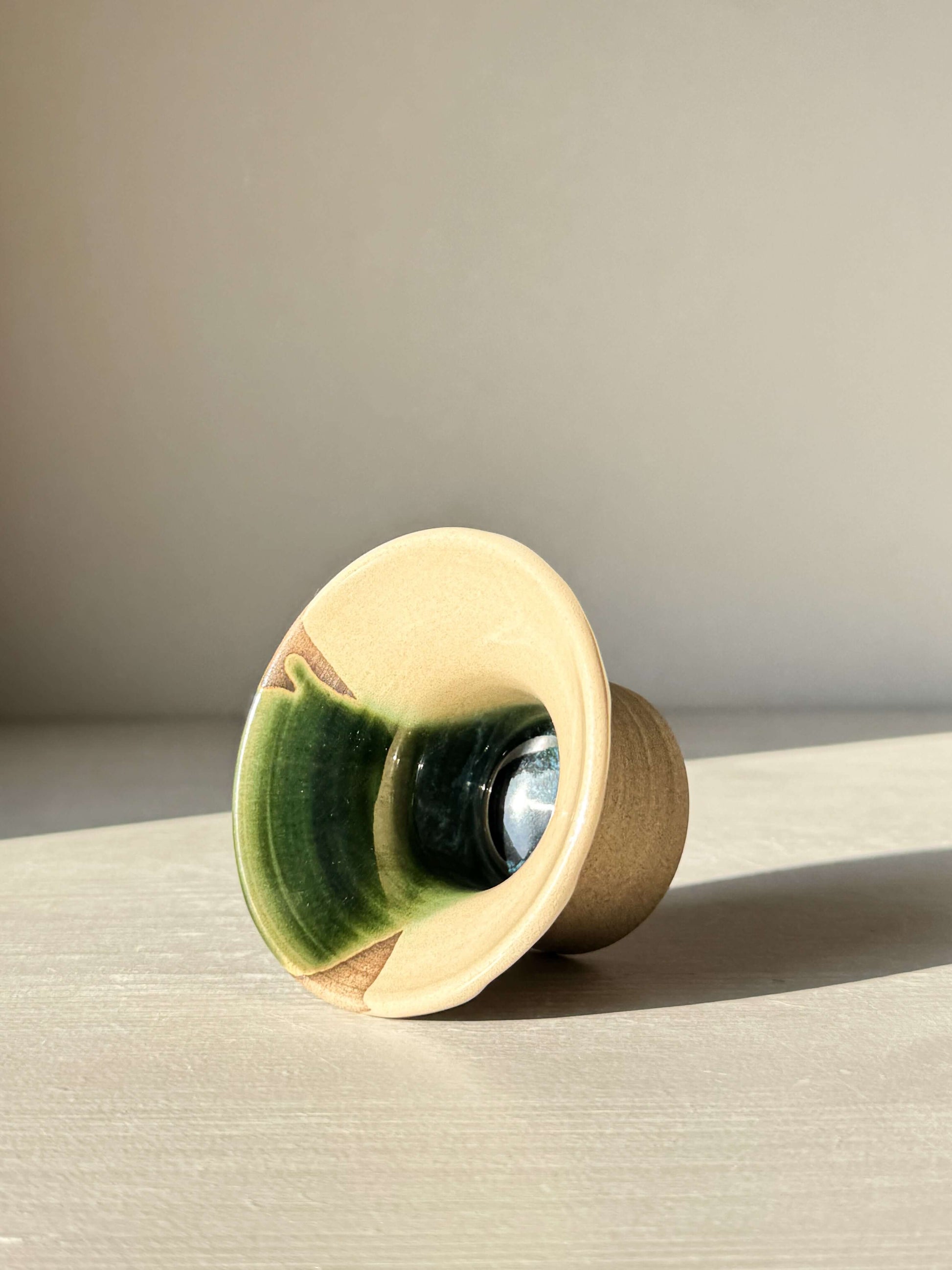 Egg Cup - Mori handmade ceramic with green glaze, showcasing its wide, flared rim design on warm stoneware.