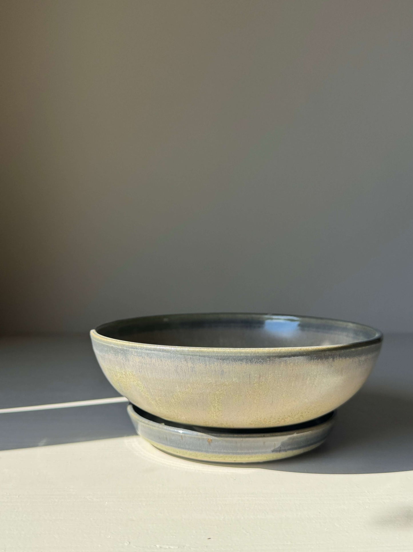 Berry Bowl - Satin Blue handmade ceramic with soft curves and satin glaze, featuring drainage holes and a matching drip plate.