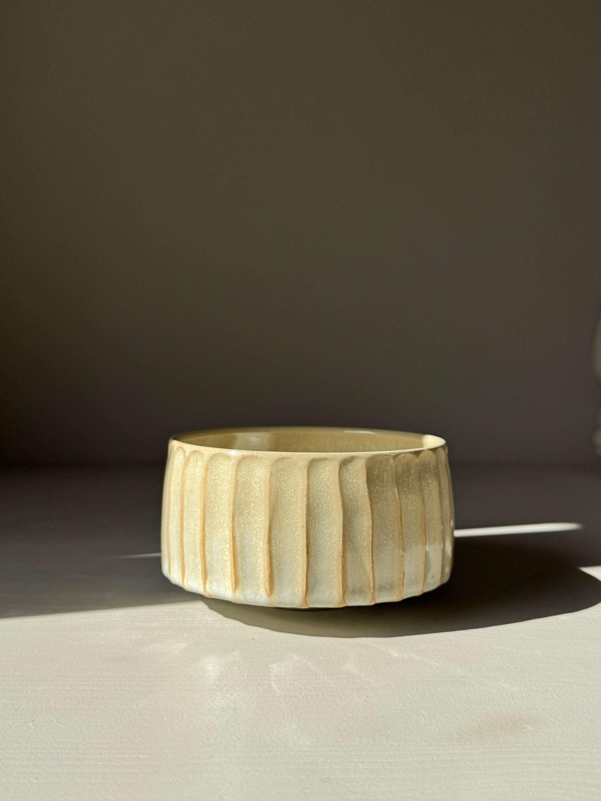 Carved Matcha Bowl – Moonstone Glaze #01 handmade ceramic with hand-cut ridges and pale glaze, reflecting minimalist design elegance.