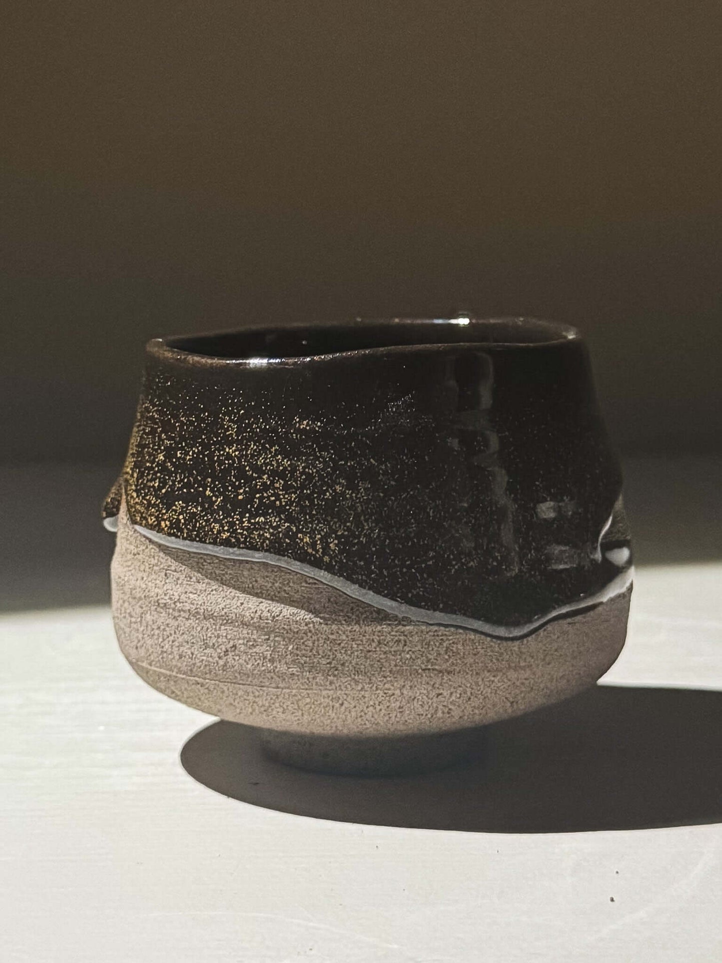 Yunomi Cup - Kuro Ash #03 with glossy black glaze and golden speckles, handmade stoneware pottery.