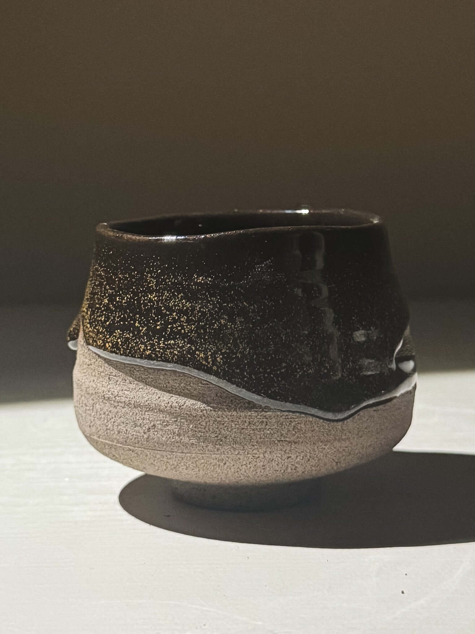 Yunomi Cup - Kuro Ash #03 with glossy black glaze and golden speckles, handmade stoneware pottery.