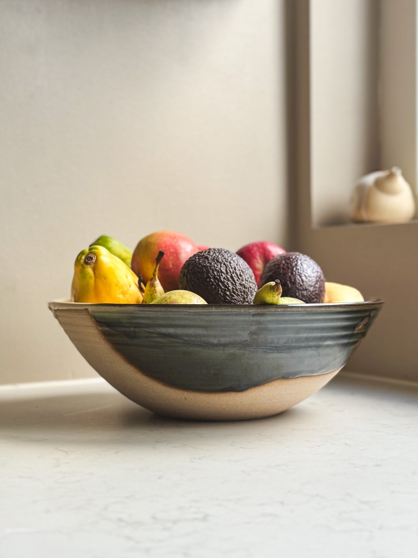 Large Bowl - Mori #02 with glossy green glaze, filled with fruits, showing deep rounded form and rich emerald tones.