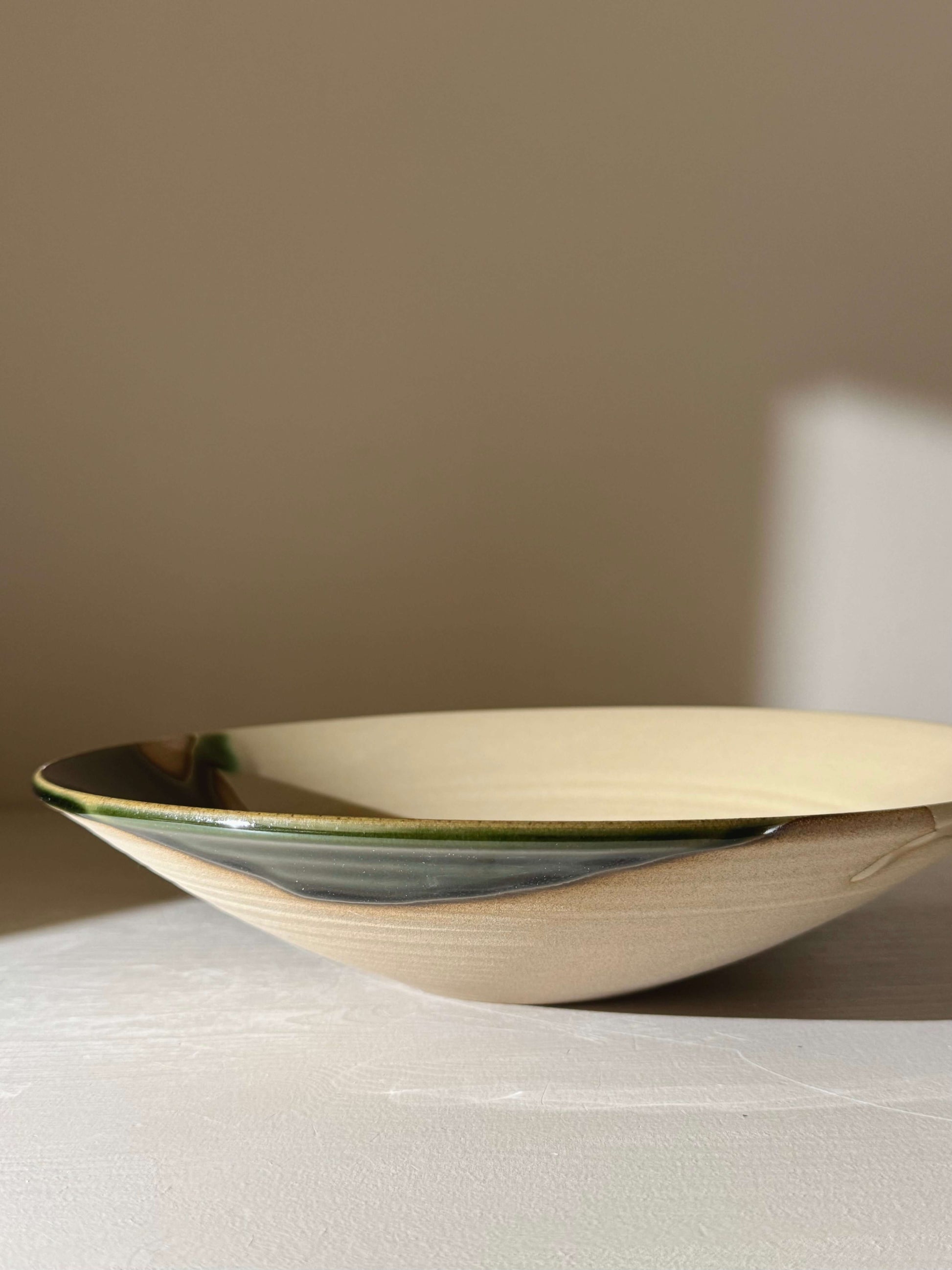 Large Shallow Bowl - Mori Series handmade ceramic with green glaze, featuring depth and movement, ideal for shared meals and decor.