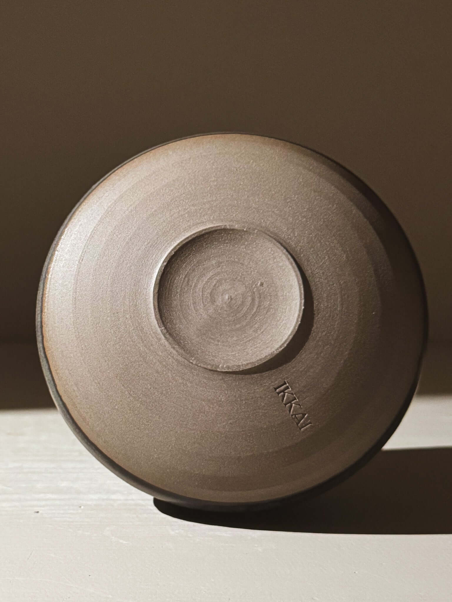 Bottom view of Matcha Bowl - Black Truffle #03 showing stoneware clay and matte glaze.