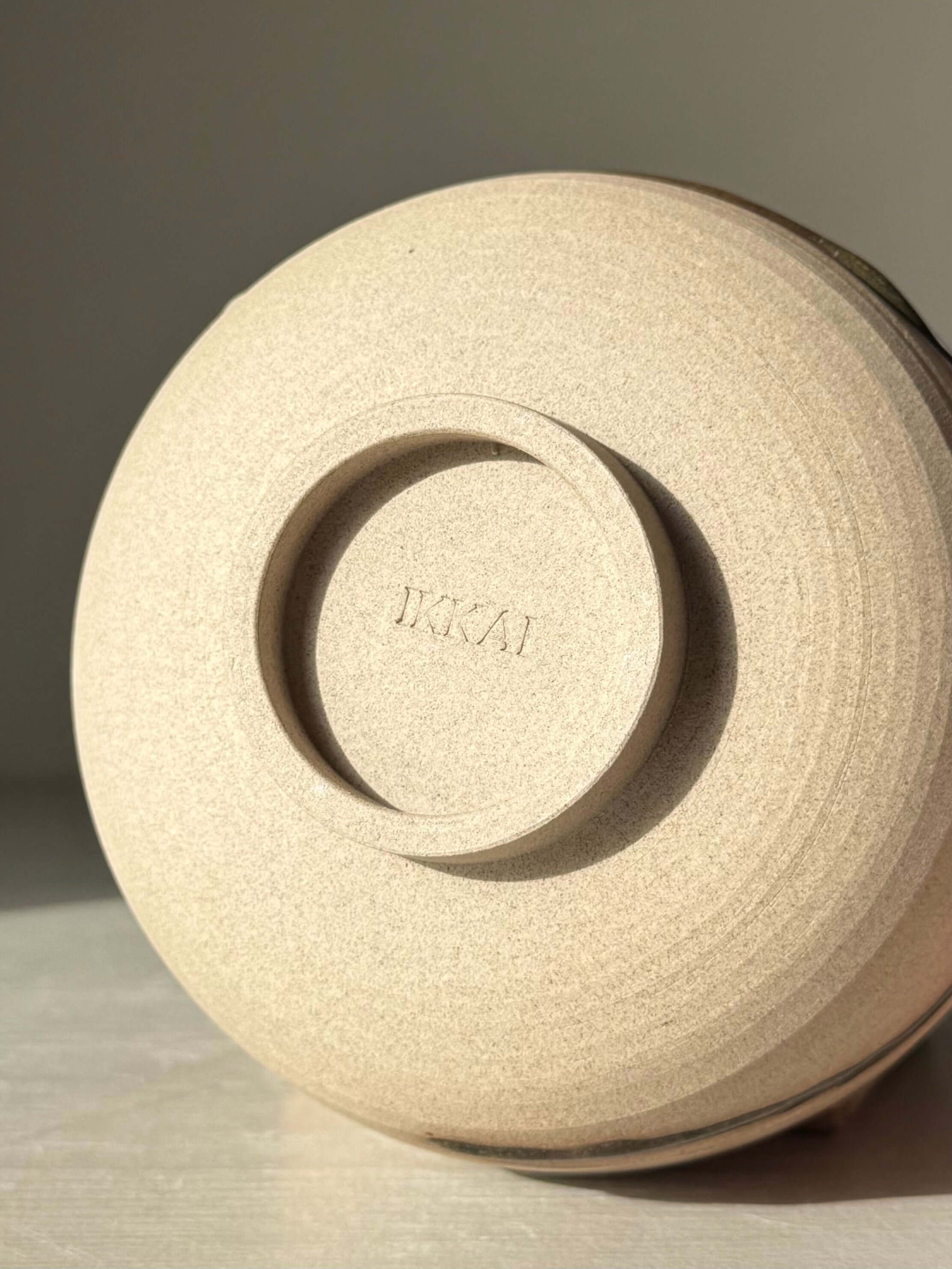 Underside of Matcha Bowl – Inyo #05 showcasing handmade ceramic details and warm stoneware texture in natural lighting.