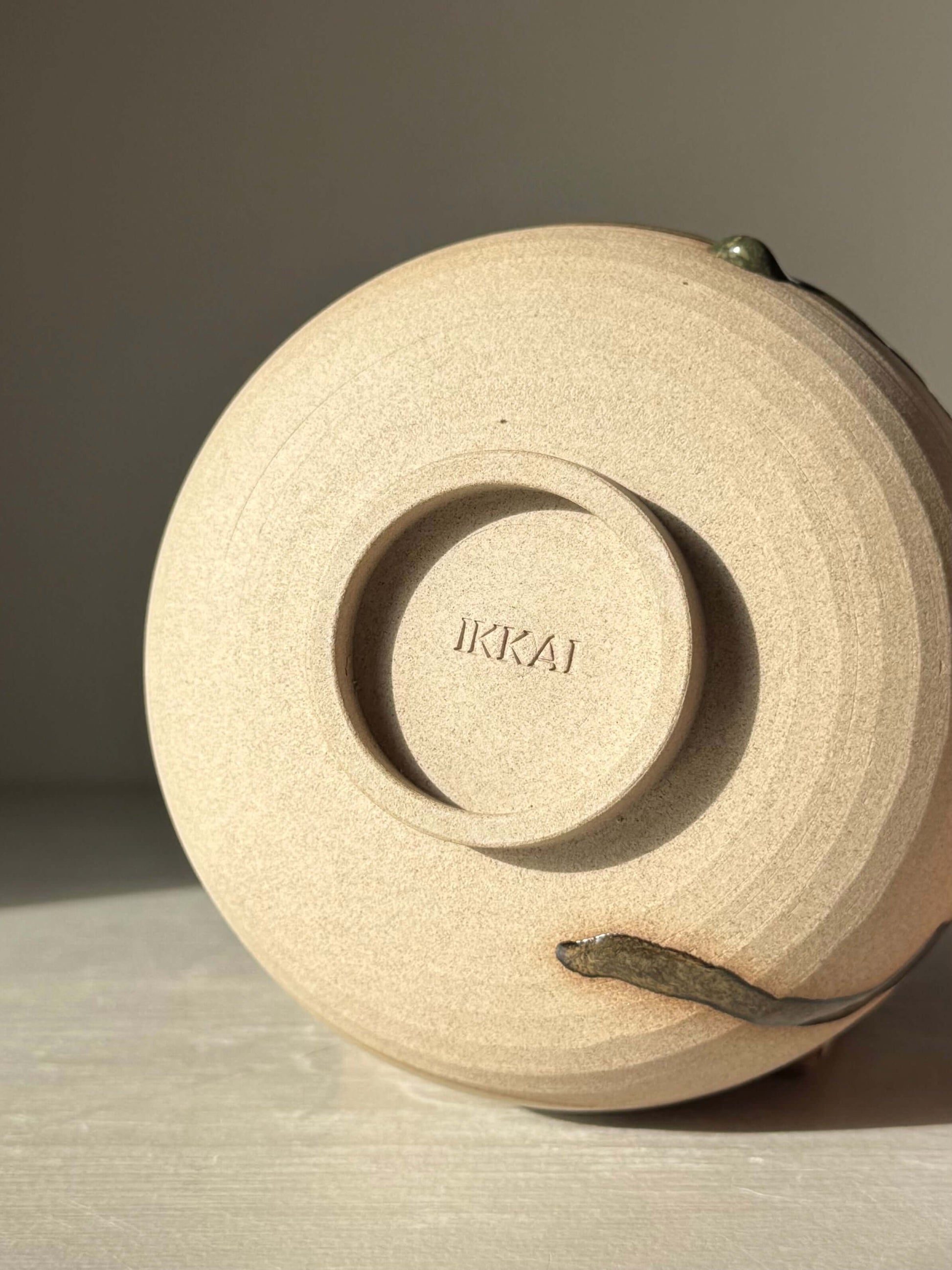 Bottom view of Matcha Bowl – Inyo #01, handmade ceramic bowl showing the signature mark.