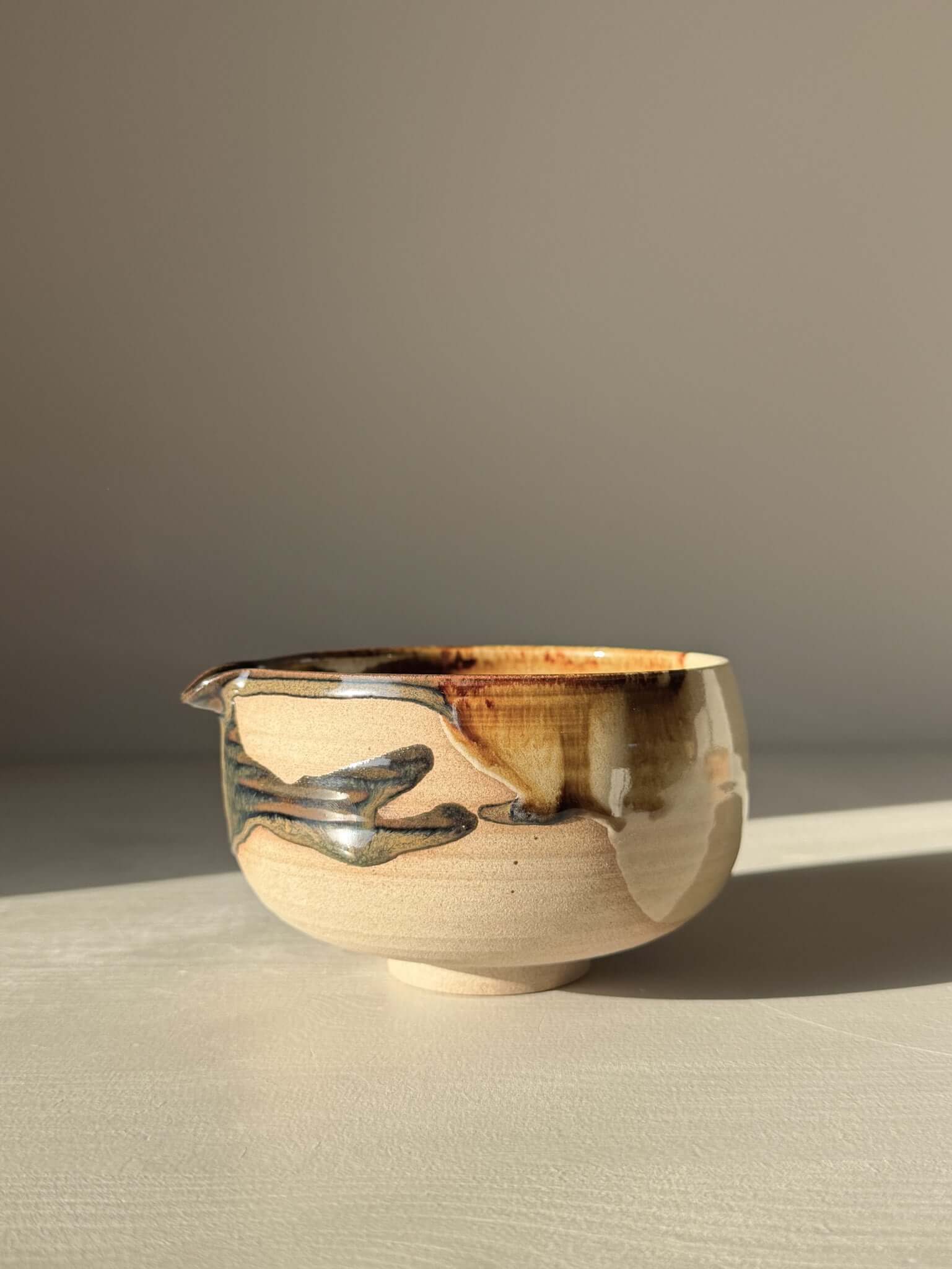 Handmade ceramic Matcha Bowl with Spout – Inyo #06 featuring unique tenmoku and clear glazes on stoneware clay.