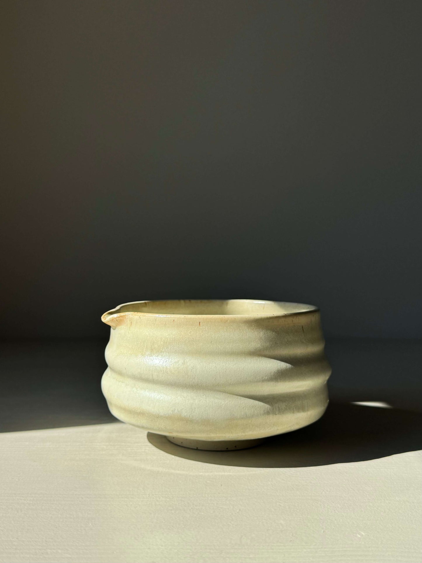 Handmade ceramic Matcha Bowl with Spout – Moonstone Glaze in a ridged design, perfect for whisking matcha, displayed in natural light.