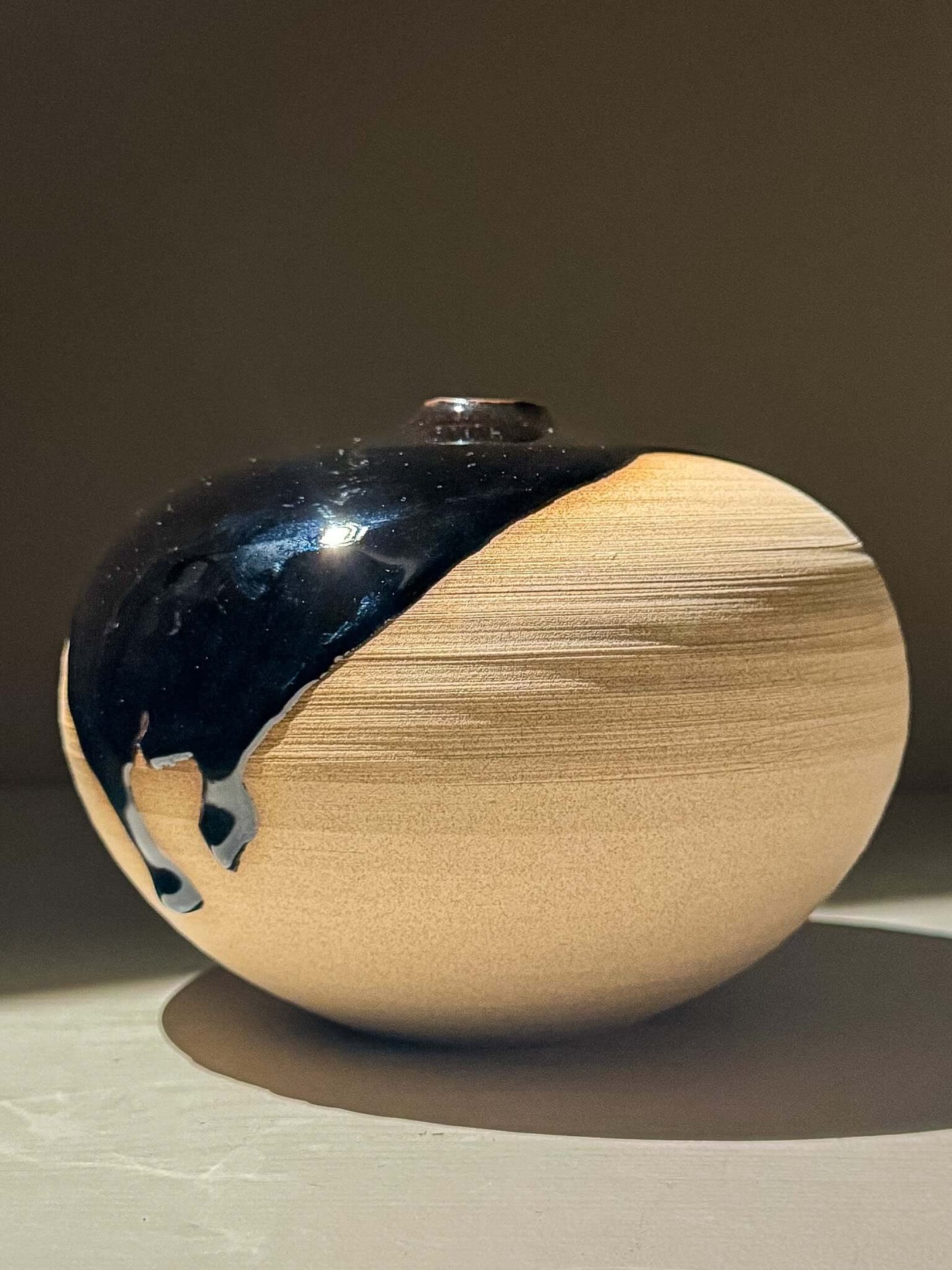 Orb Vase – Kuro #01, a unique Japanese handmade ceramic orb vase with organic glaze patterns.